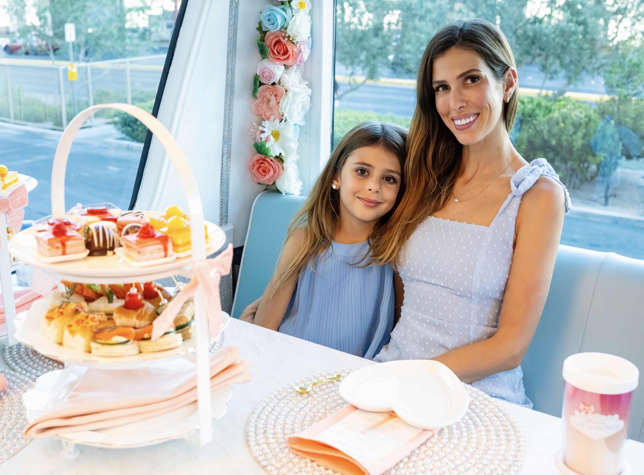 A three-tiered platter of tea sandwiches, scones, and sweets aboard the coach