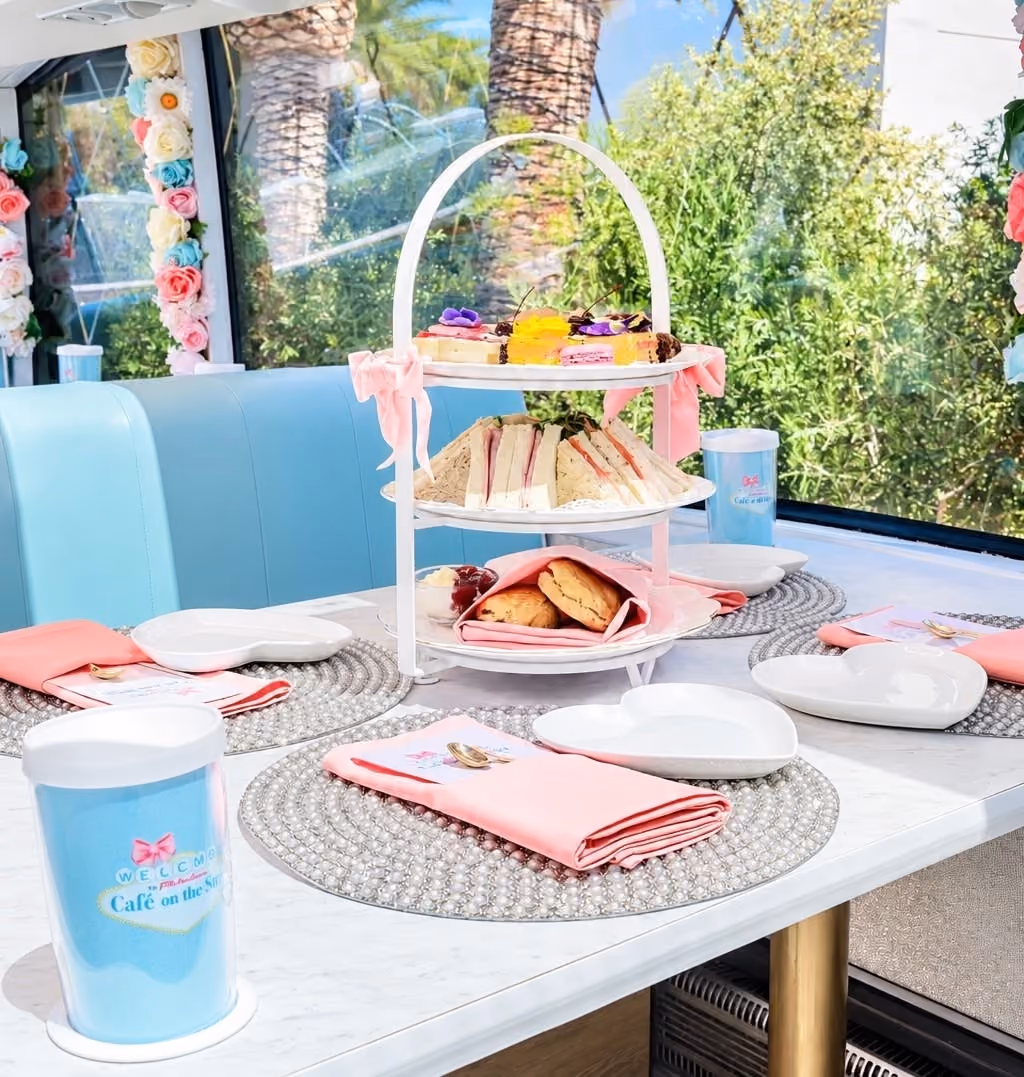 A three-tiered platter of tea sandwiches, scones, and sweets aboard the coach