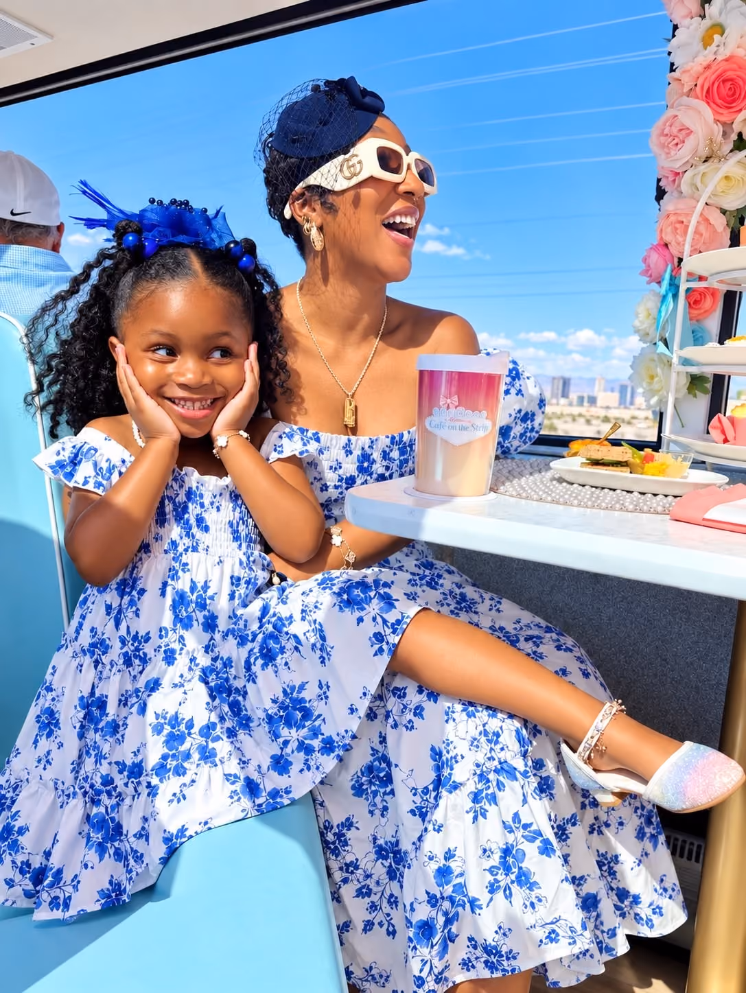 Mother and daughter in matching blue floral dresses on the tea tour