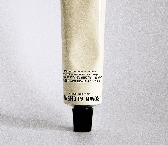 Tube of Grow Alchemist Hydr+ Repair Day Cream on a white surface.