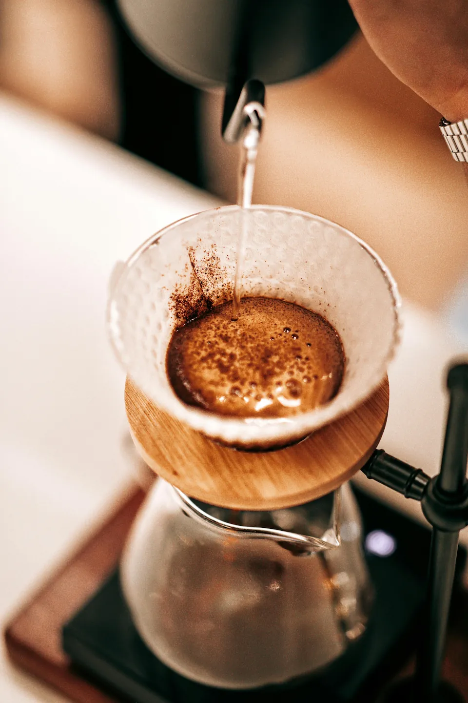 Pour-over coffee brewing into a glass carafe
