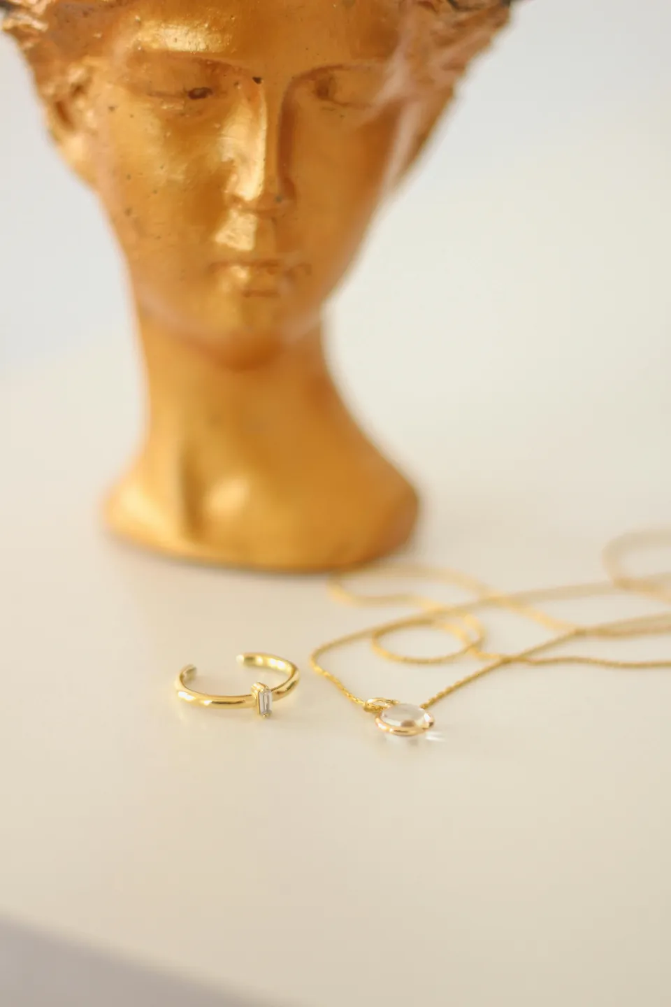 A gold ring and necklace displayed