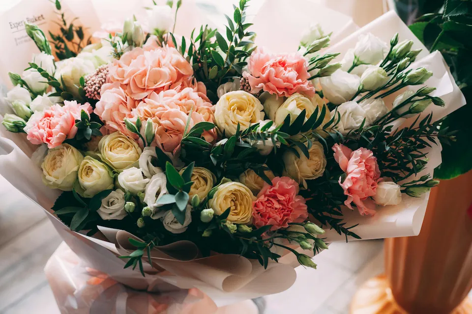 A bouquet of pink, peach, and white flowers
