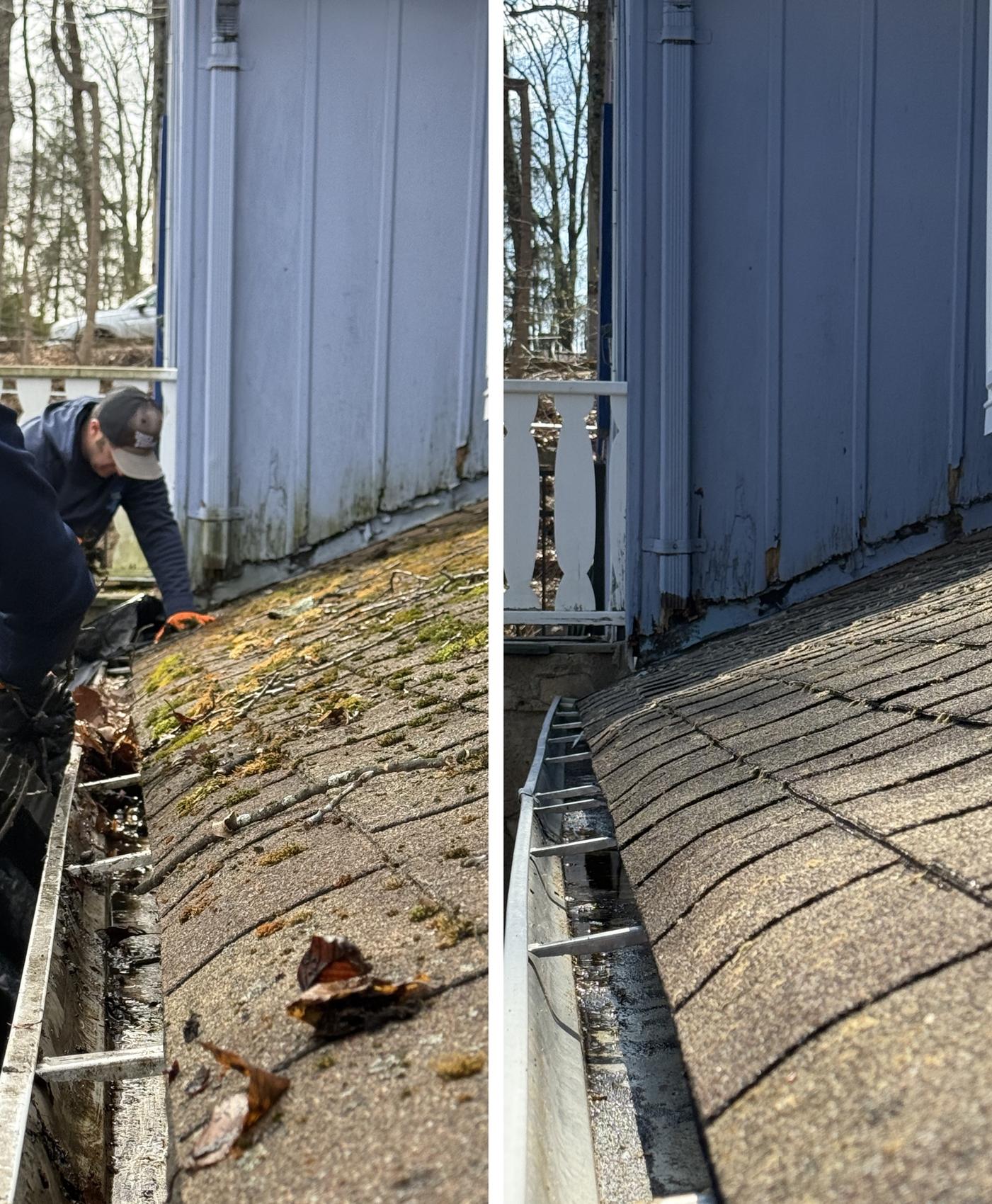 Technician scooping leaves and moss from a clogged gutter on a New Jersey home