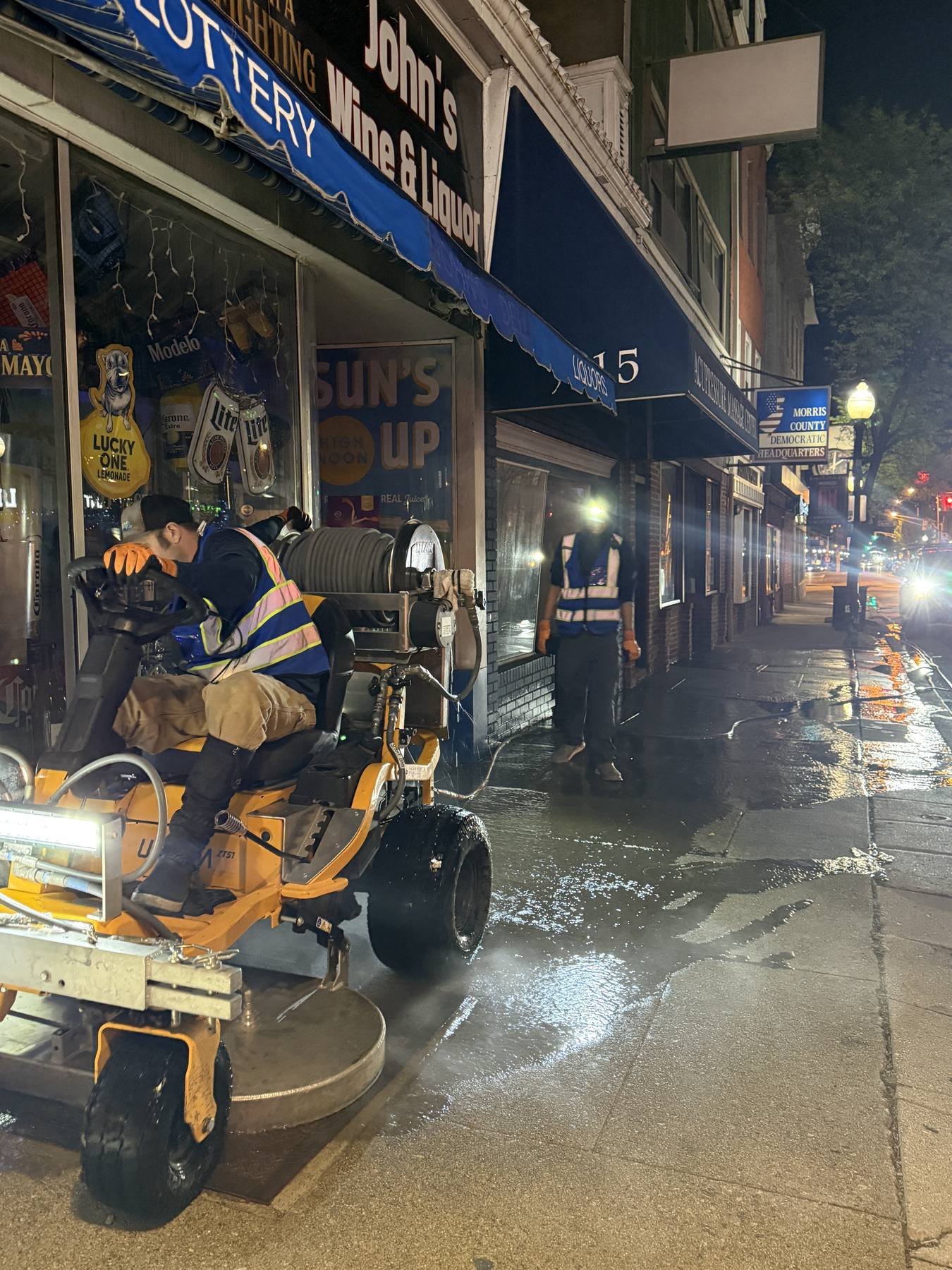 Ride-on surface cleaner washing a commercial sidewalk in downtown Morristown, NJ