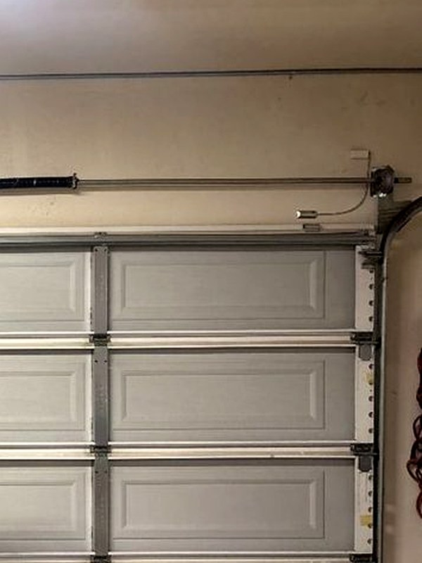 Garage door track, cable drum and end bearing plate at a Menifee repair