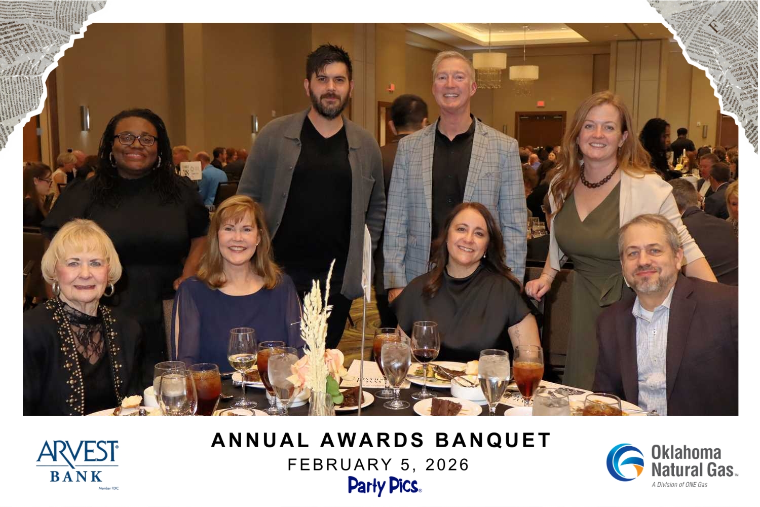 Group of eight people smiling at a banquet table with drinks and dessert plates, taken at the Annual Awards Banquet on February 5, 2026, with logos for Arvest Bank and Oklahoma Natural Gas.
