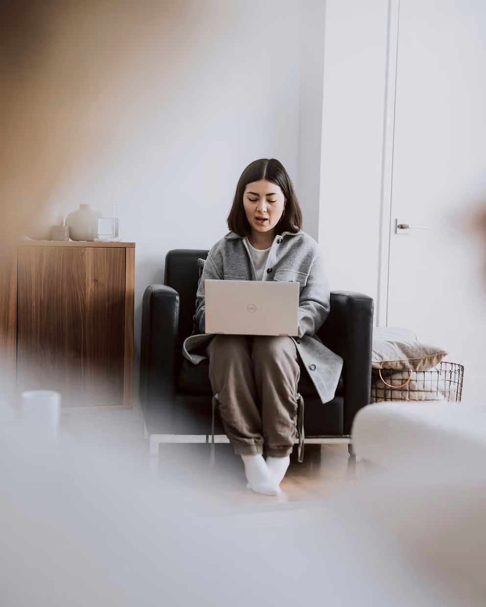 A woman sitting and working on her laptop