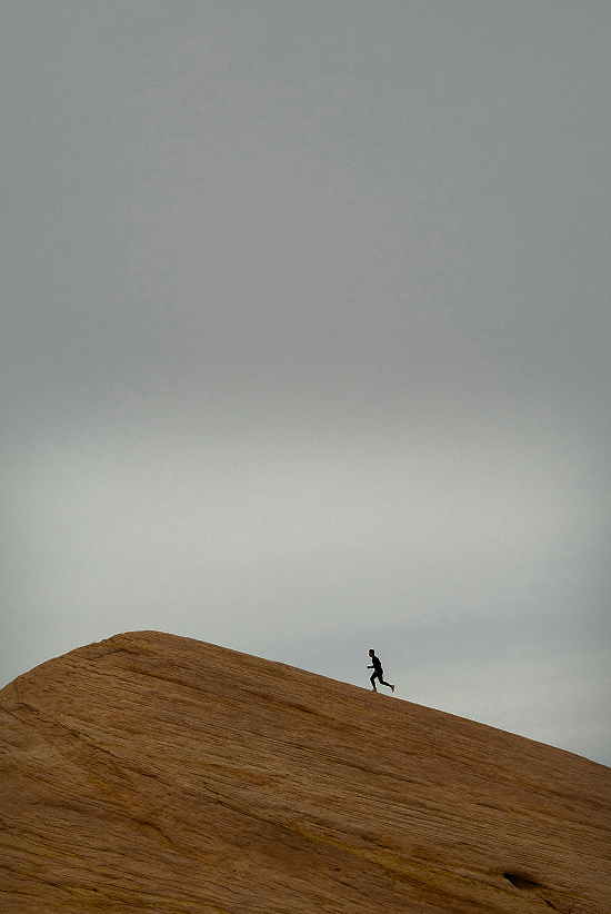 a man running up a dirt hill