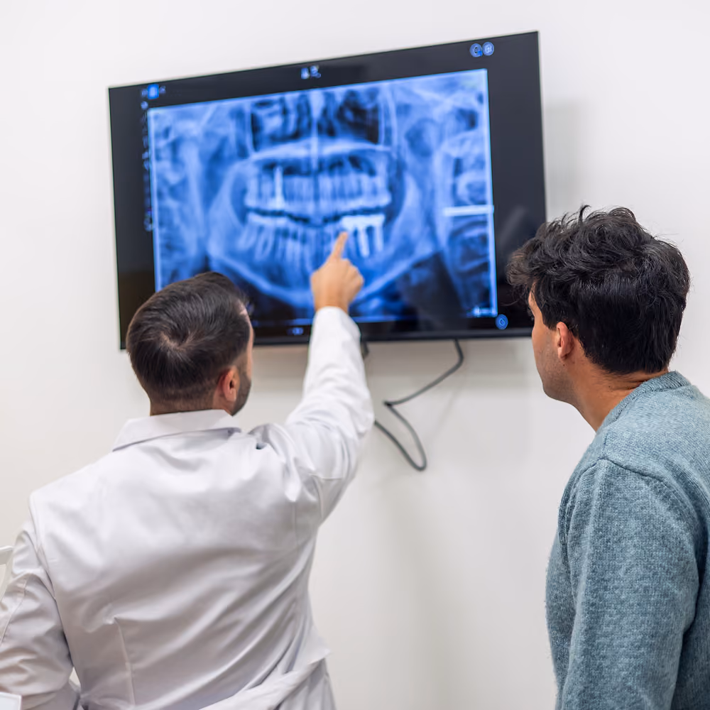 Patient and clinician reviewing an implant treatment plan at Restore Dental Implant Studio