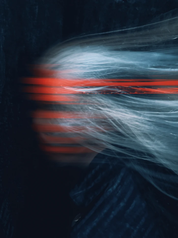 Abstract face with dynamic light trails.