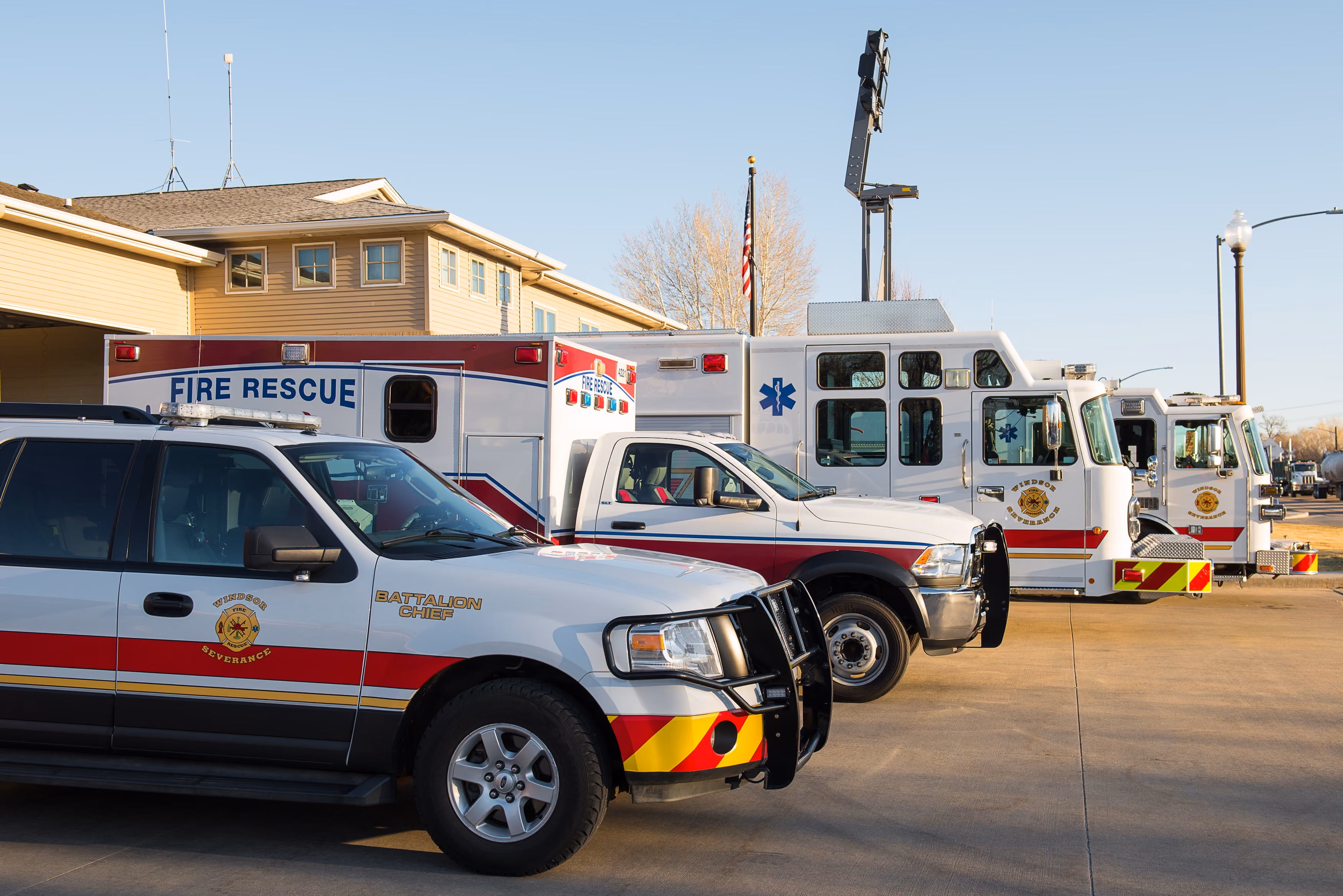 Lineup of Windsor Severance fire rescue and emergency vehicles parked outside a station.