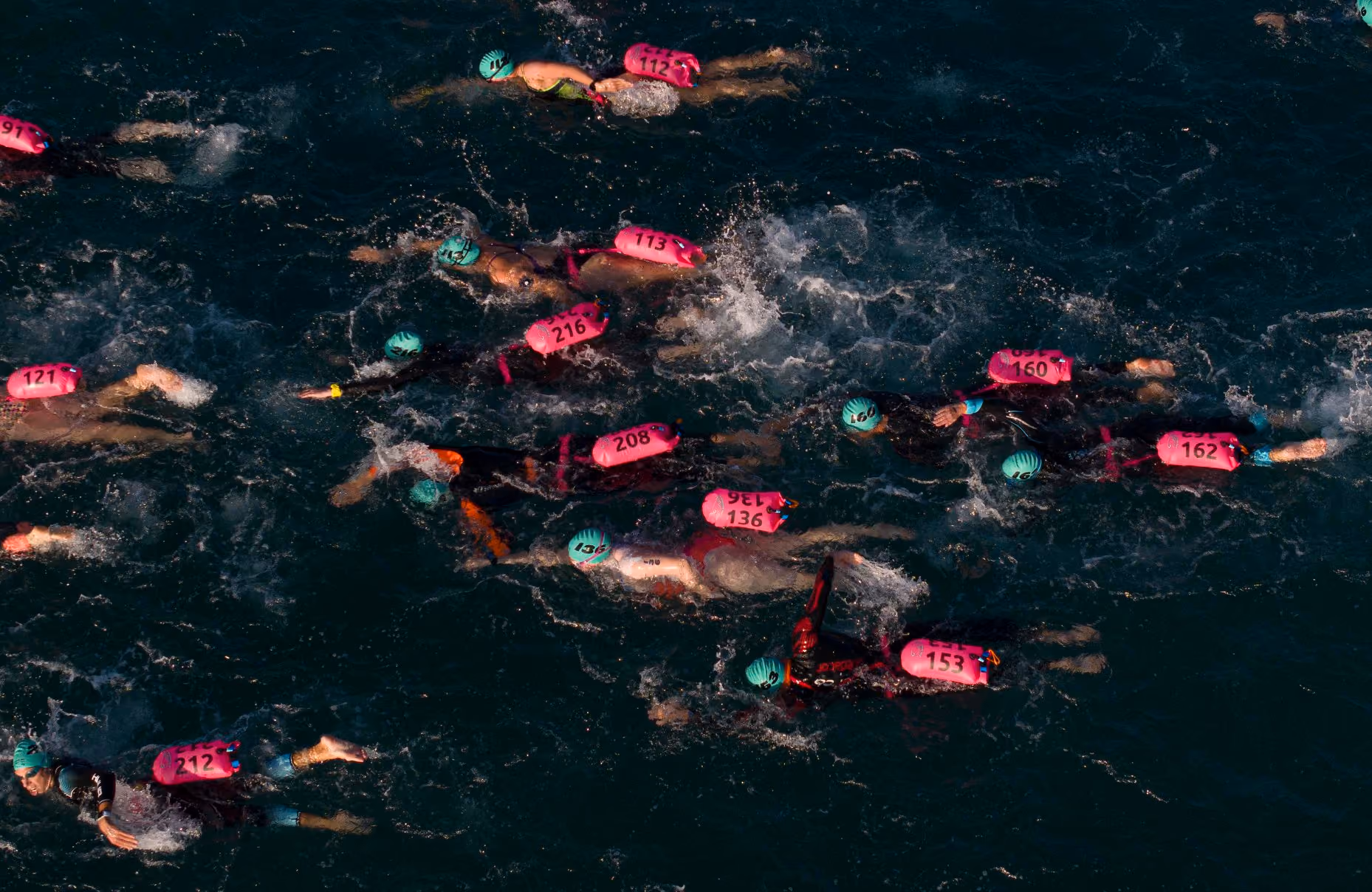 Swimmers in warm open water at an UltraSwim 33.3 event in Greece