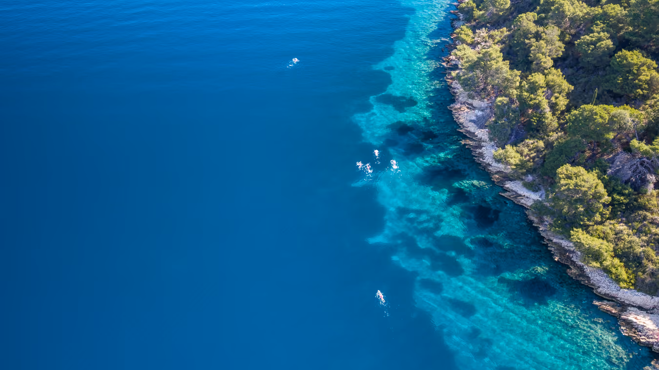 Swimmers in warm open water at an UltraSwim 33.3 event in Greece