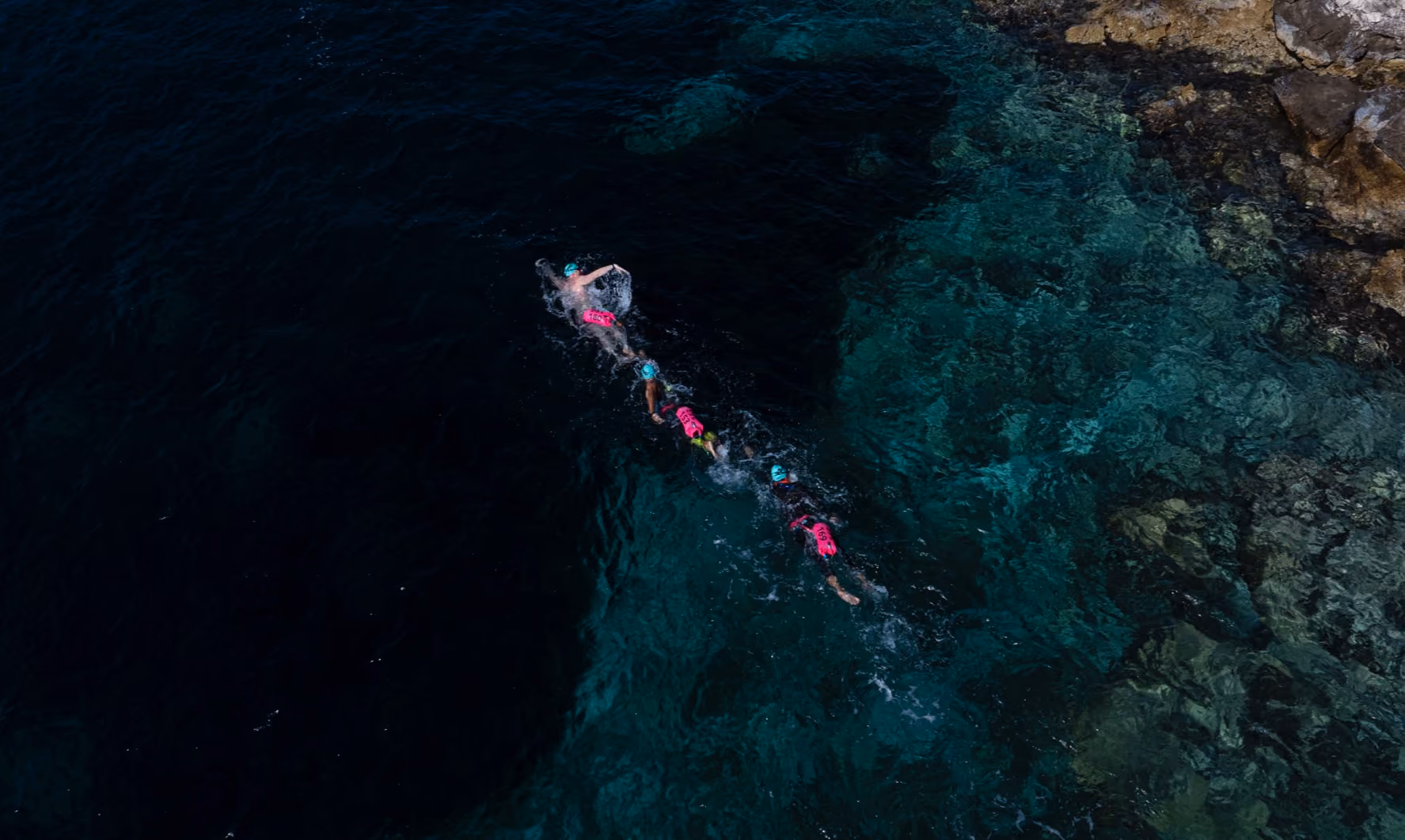 Swimmers in warm open water at an UltraSwim 33.3 event in Greece