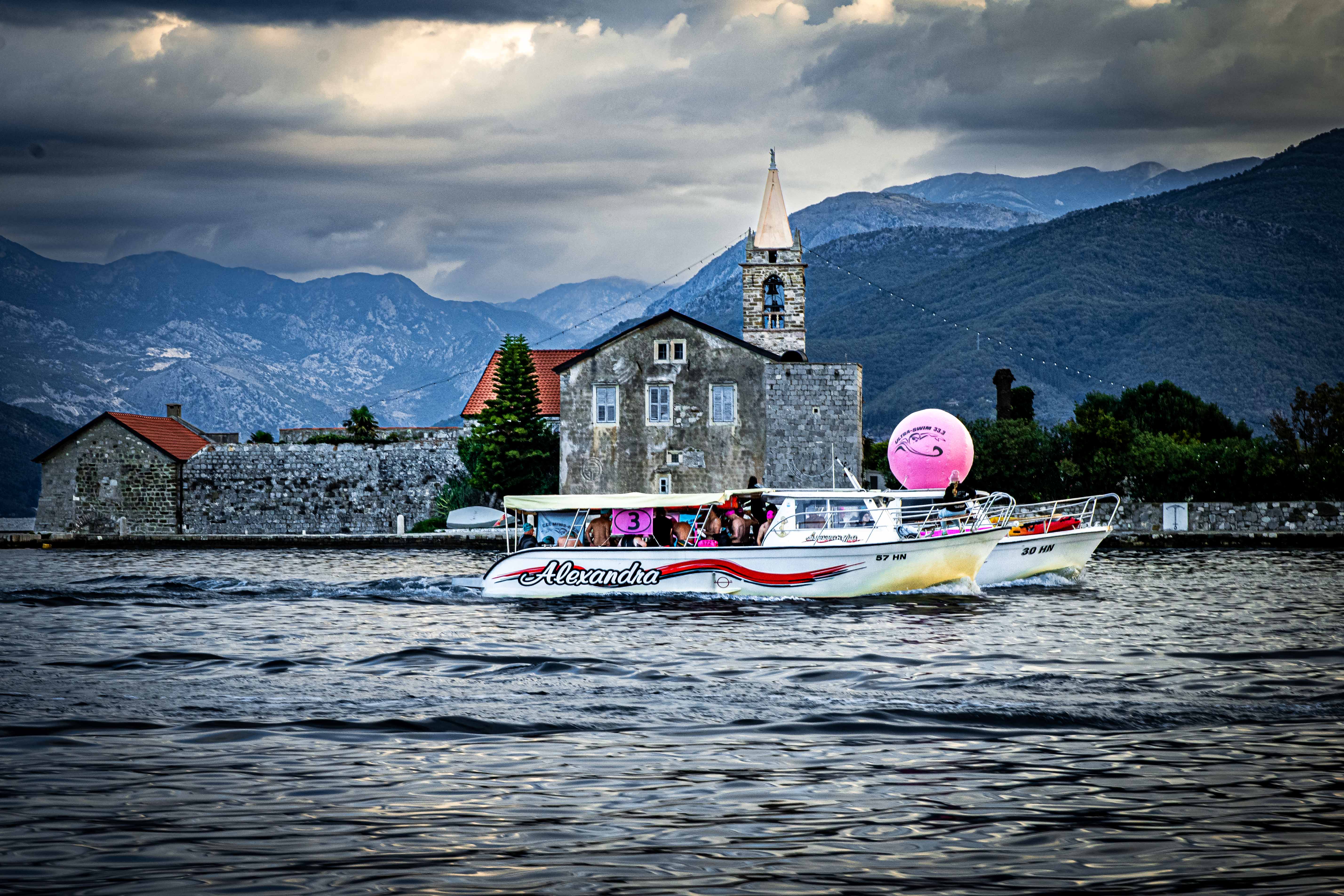 UltraSwim 33.3 #10 Montenegro, transfer boat passing the monastery