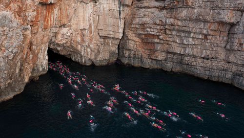 UltraSwim 33.3 swimmers from above entering the blue cave, Montenegro