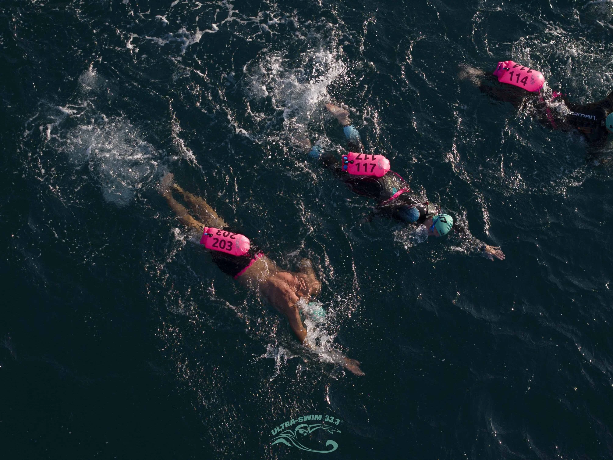 Swimmers in warm open water at an UltraSwim 33.3 event in Greece