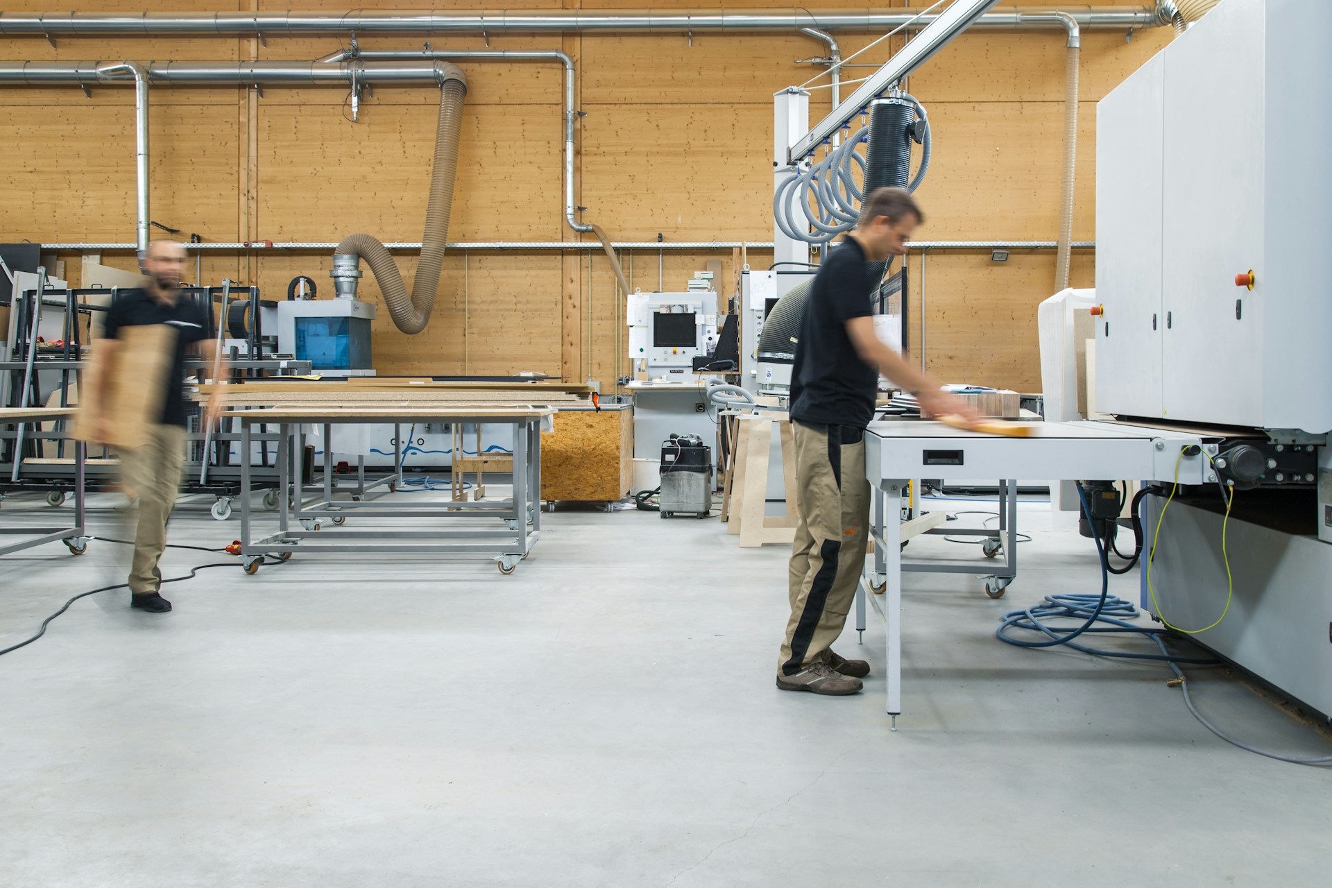 Workers in a joinery workshop with machinery