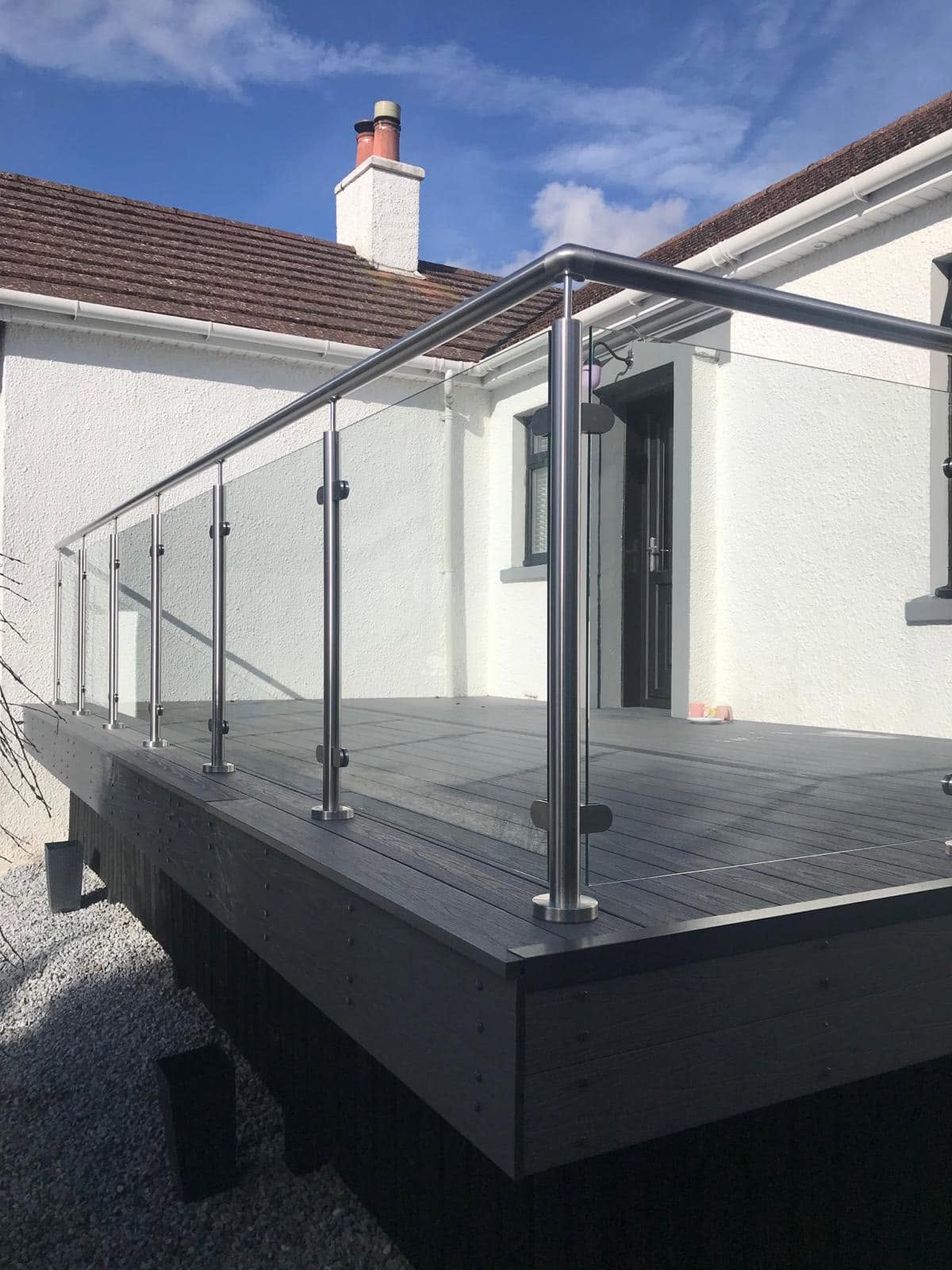 Glass balustrade with stainless steel posts on a raised outdoor decking area