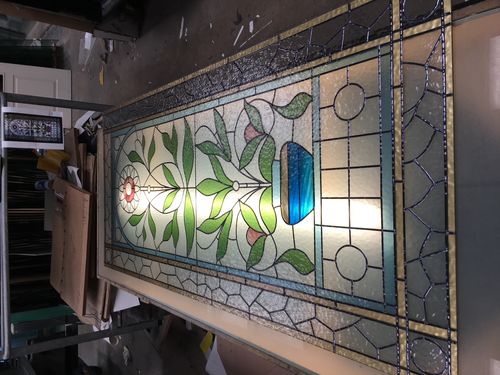 Traditional stained glass door panel with a leafy vase and flower design