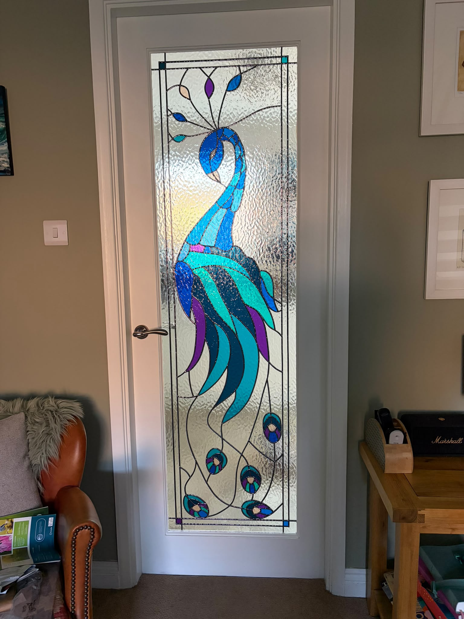 Stained glass peacock design fitted into a full length white internal door