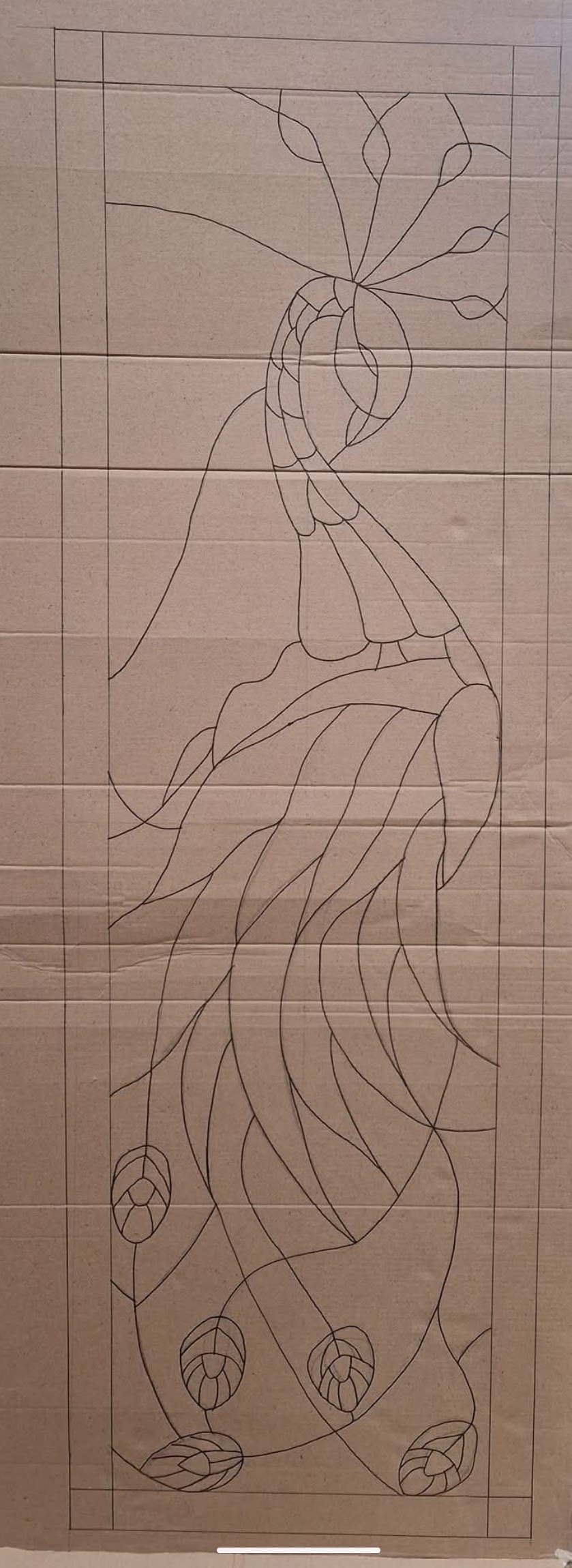 Peacock design sketch drawn on cardboard as a stained glass template