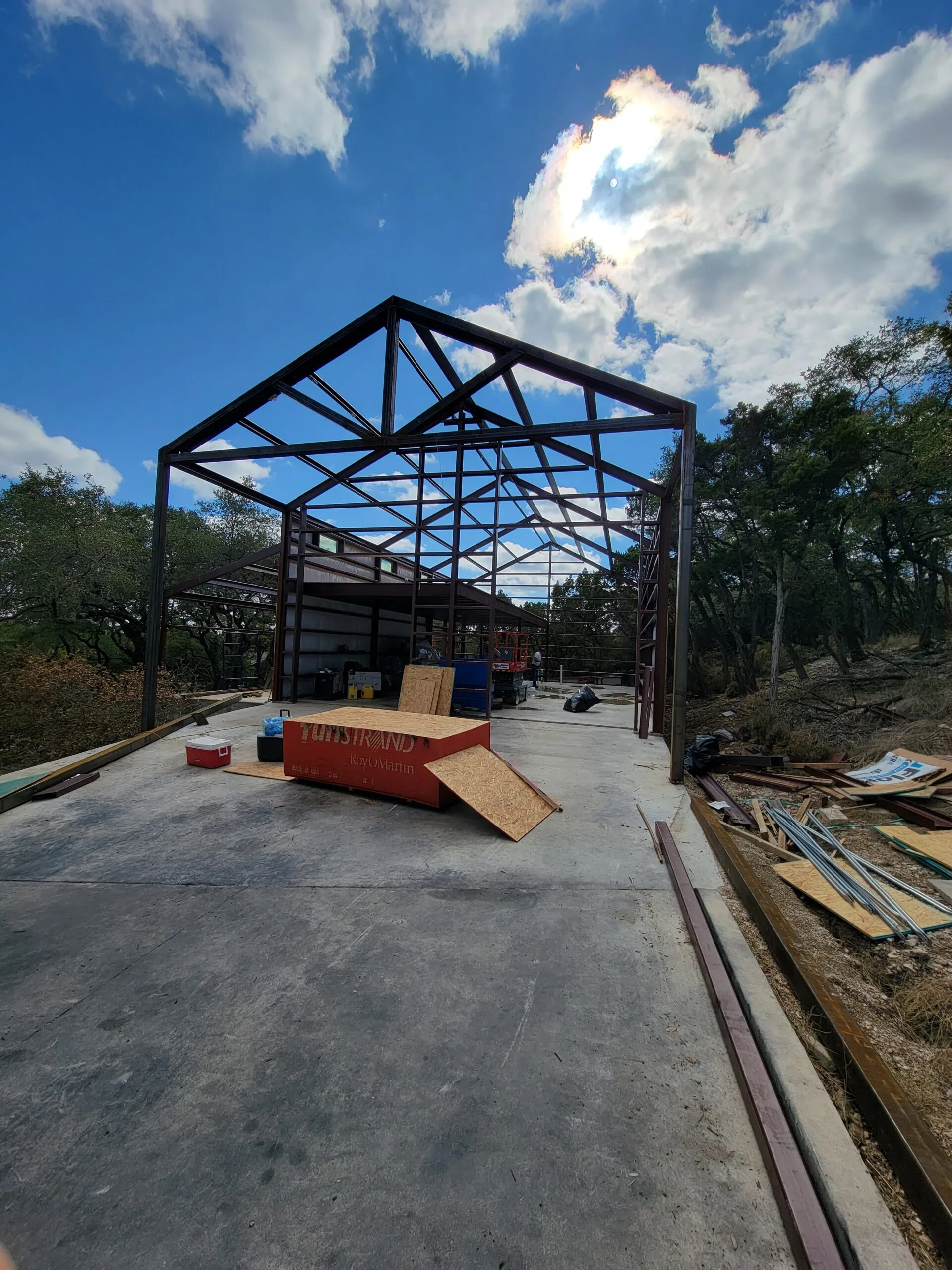 Steel frame and roof trusses erected on a poured concrete slab during RV garage construction