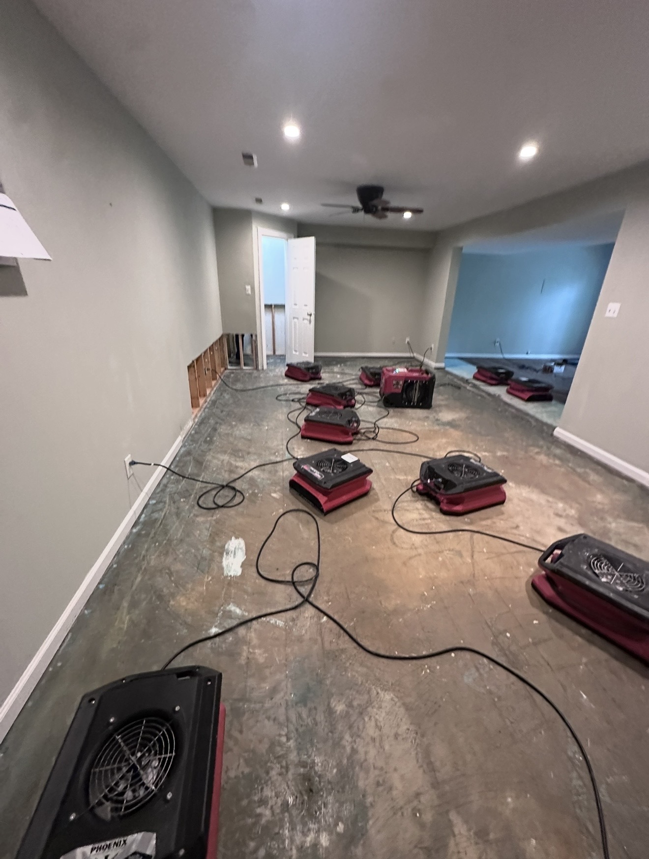 Structural drying equipment set across a residential interior during mitigation work.