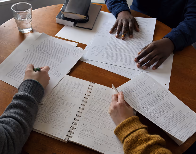 CPA members sharing handwritten notes around a table