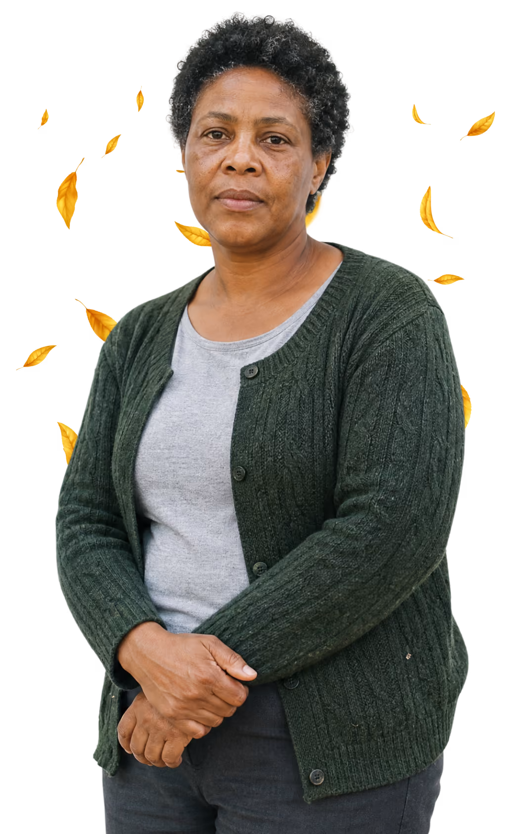 Woman in a green cardigan standing with her hands clasped