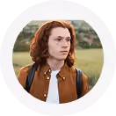 Young man with long red hair, outdoors