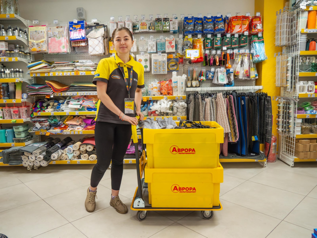 Avrora store operations team member with branded carts