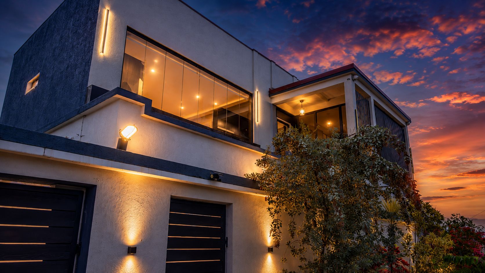 A modern villa lit at dusk