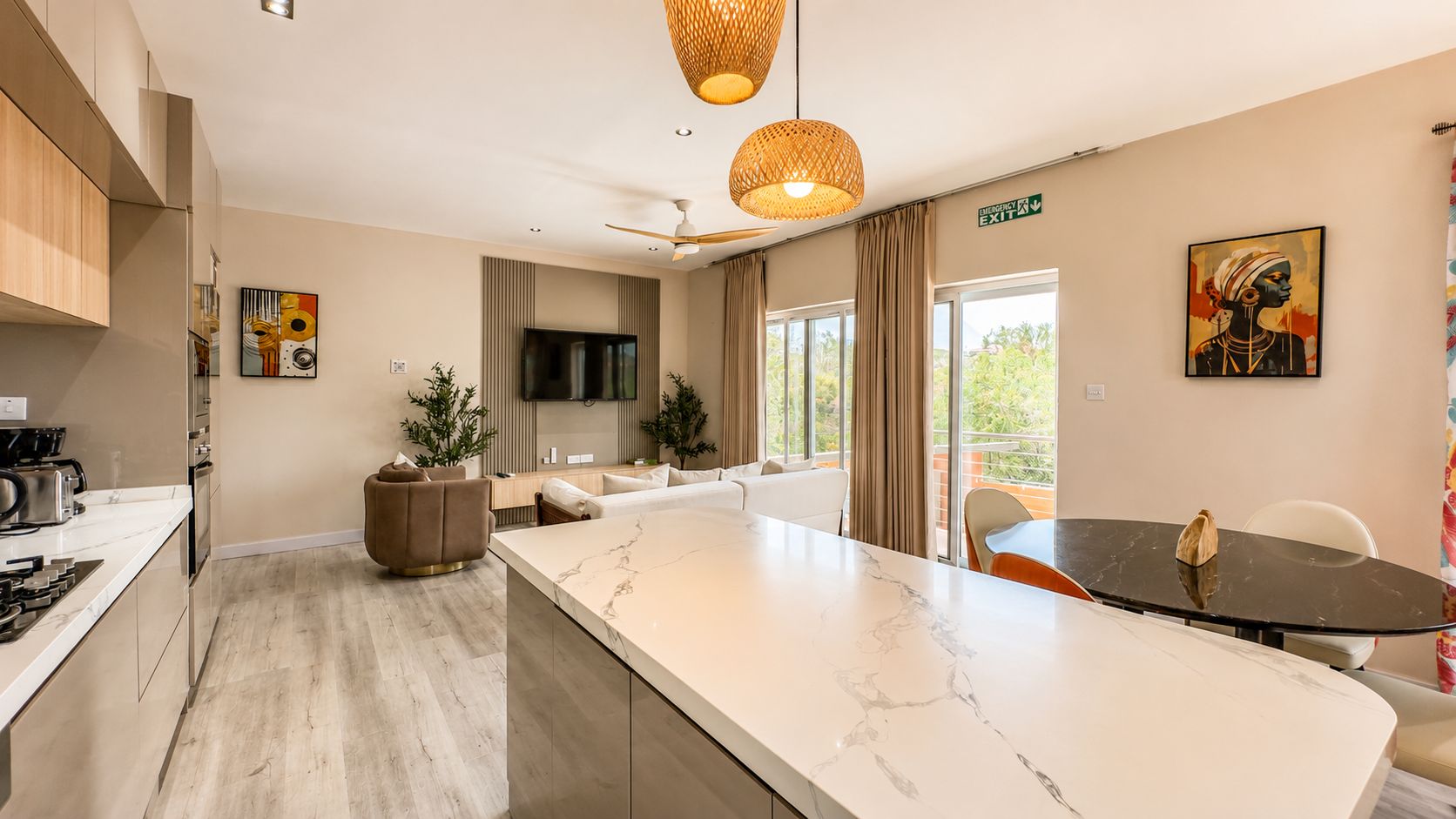 An open-plan living room and kitchen in a styled suite