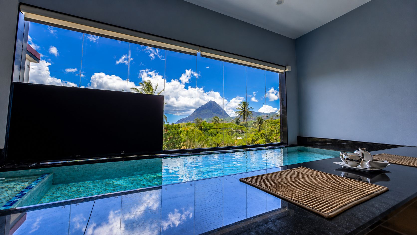An indoor plunge pool framing a view of the Piton