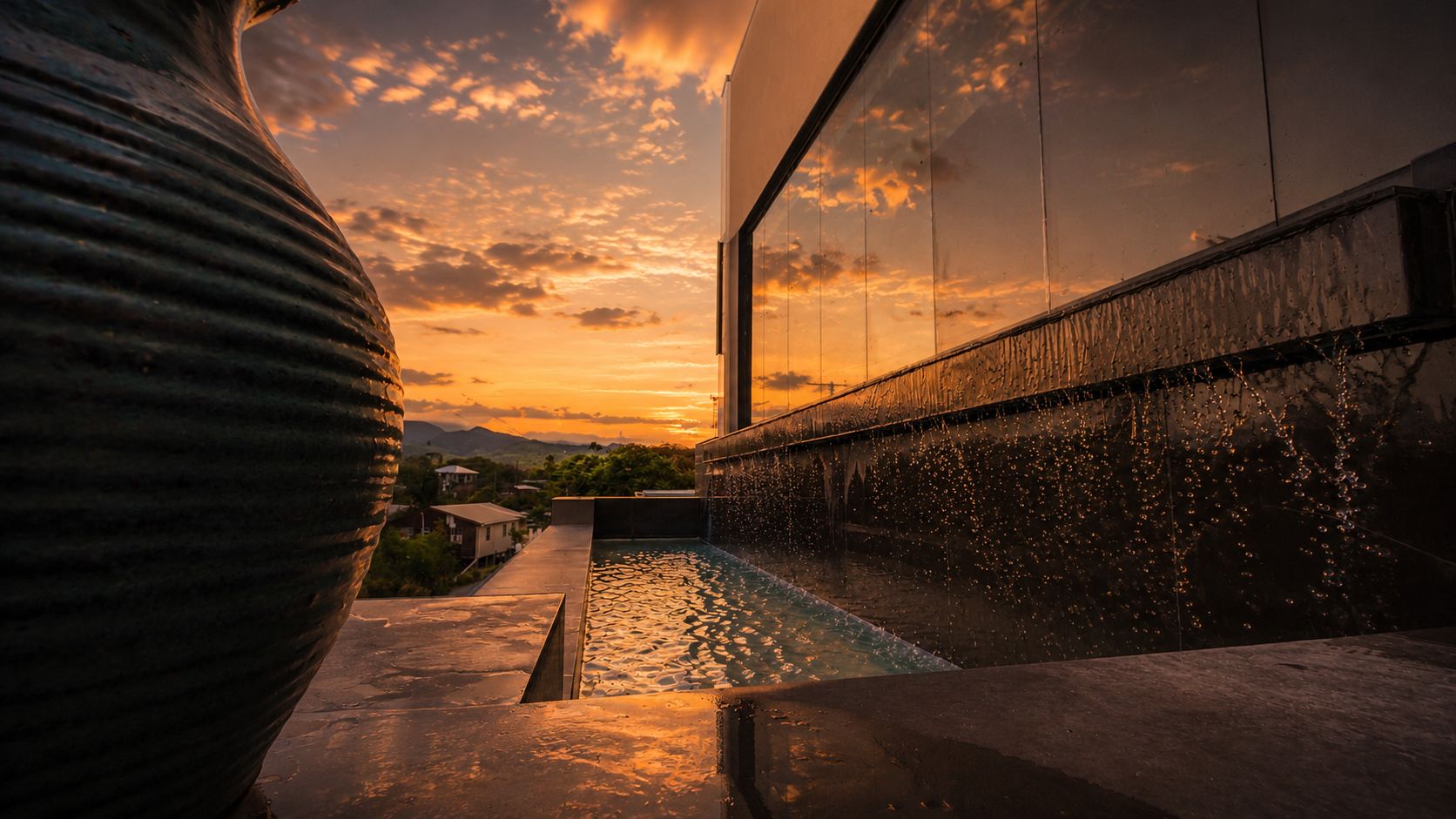 A water feature at sunset over the hills