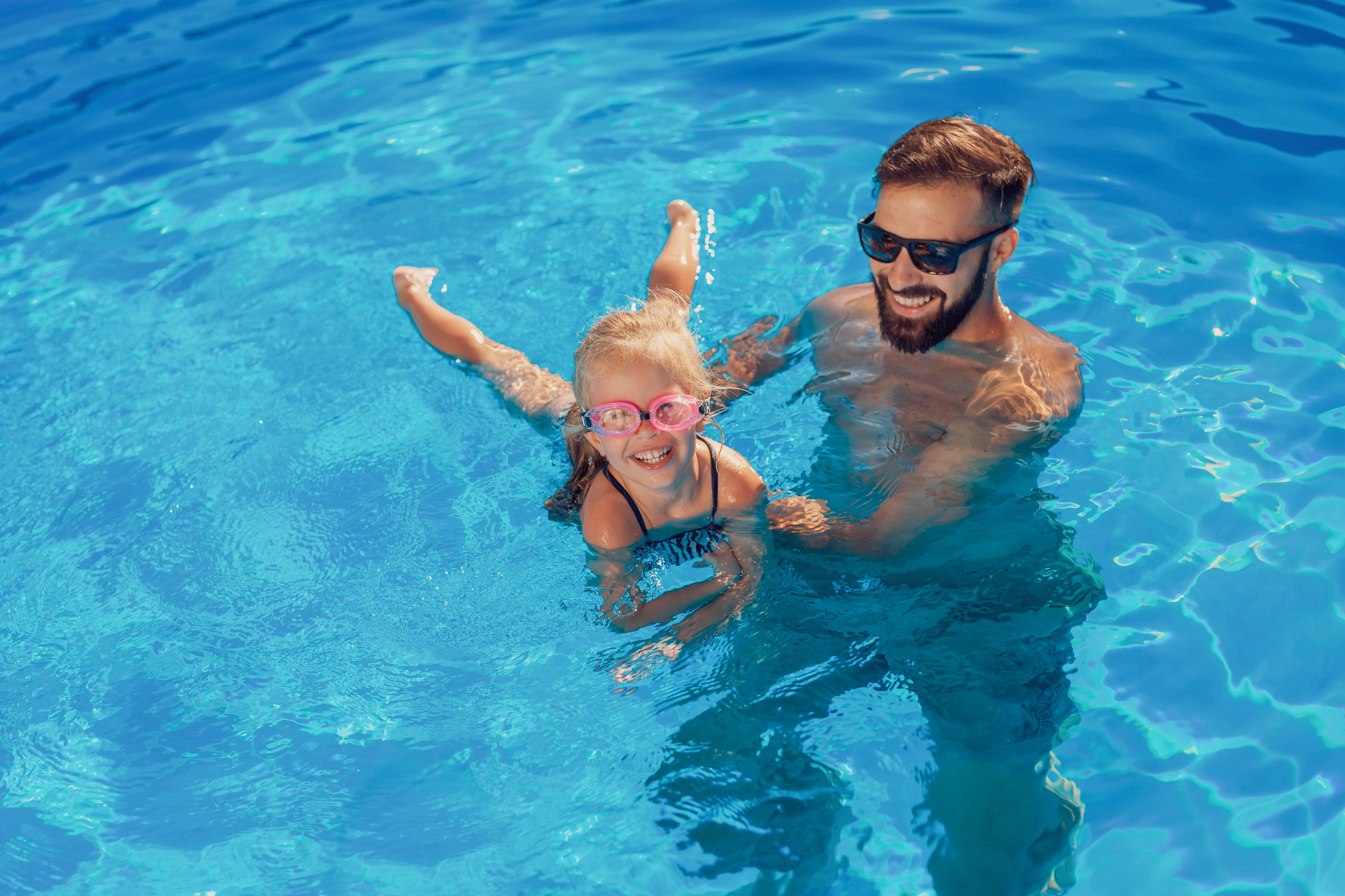 Dad with kid in the pool stock image