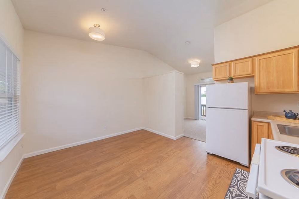 Unfurnished living area with kitchen