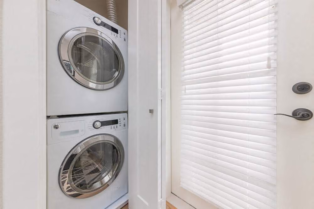 Laundry room with stacked appliances