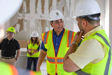 Josué Colón Ortiz, in a hard hat and safety vest, tours Pan American Pier 1 during port improvement works.