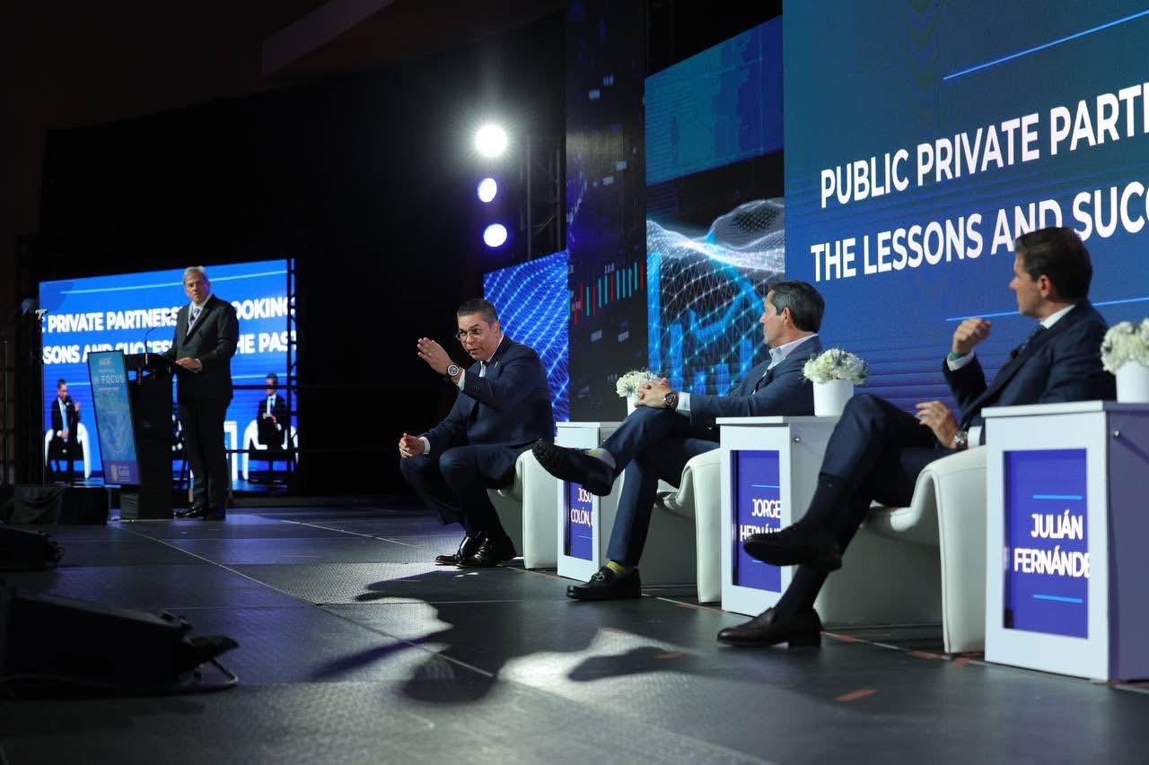 Eng. Josué A. Colón Ortiz discussing at Investment Summit 2026 with officials in forum.