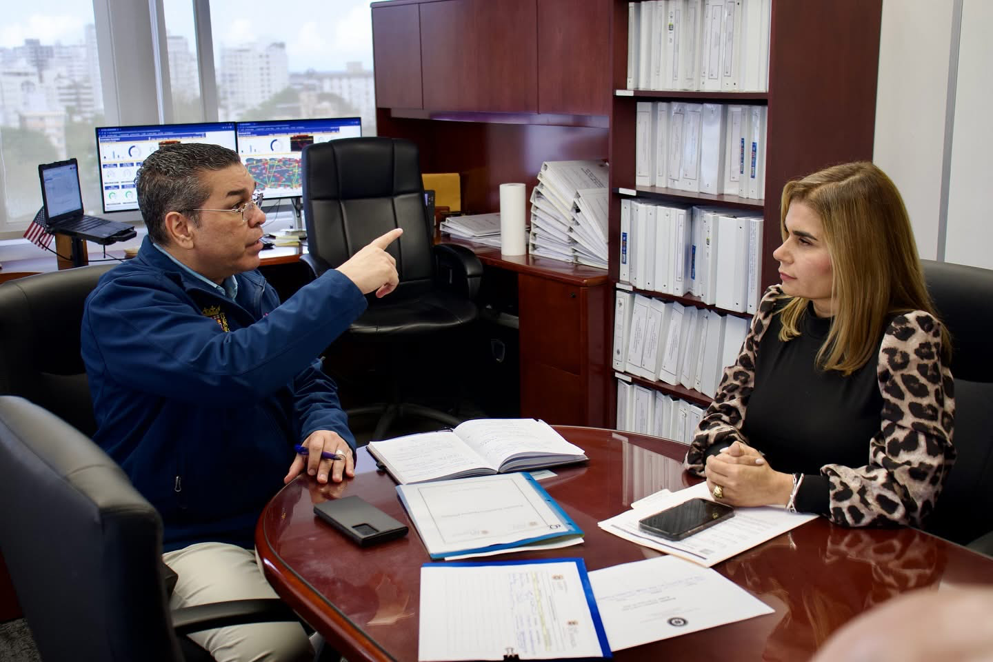 Eng. Josué Colón Ortiz discusses with Senator Marissita Jiménez at government offices.