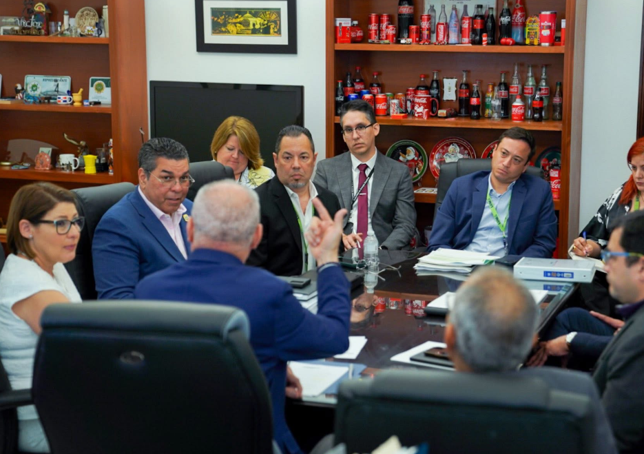 Eng. Josué Colón Ortiz discusses with officials at government offices.