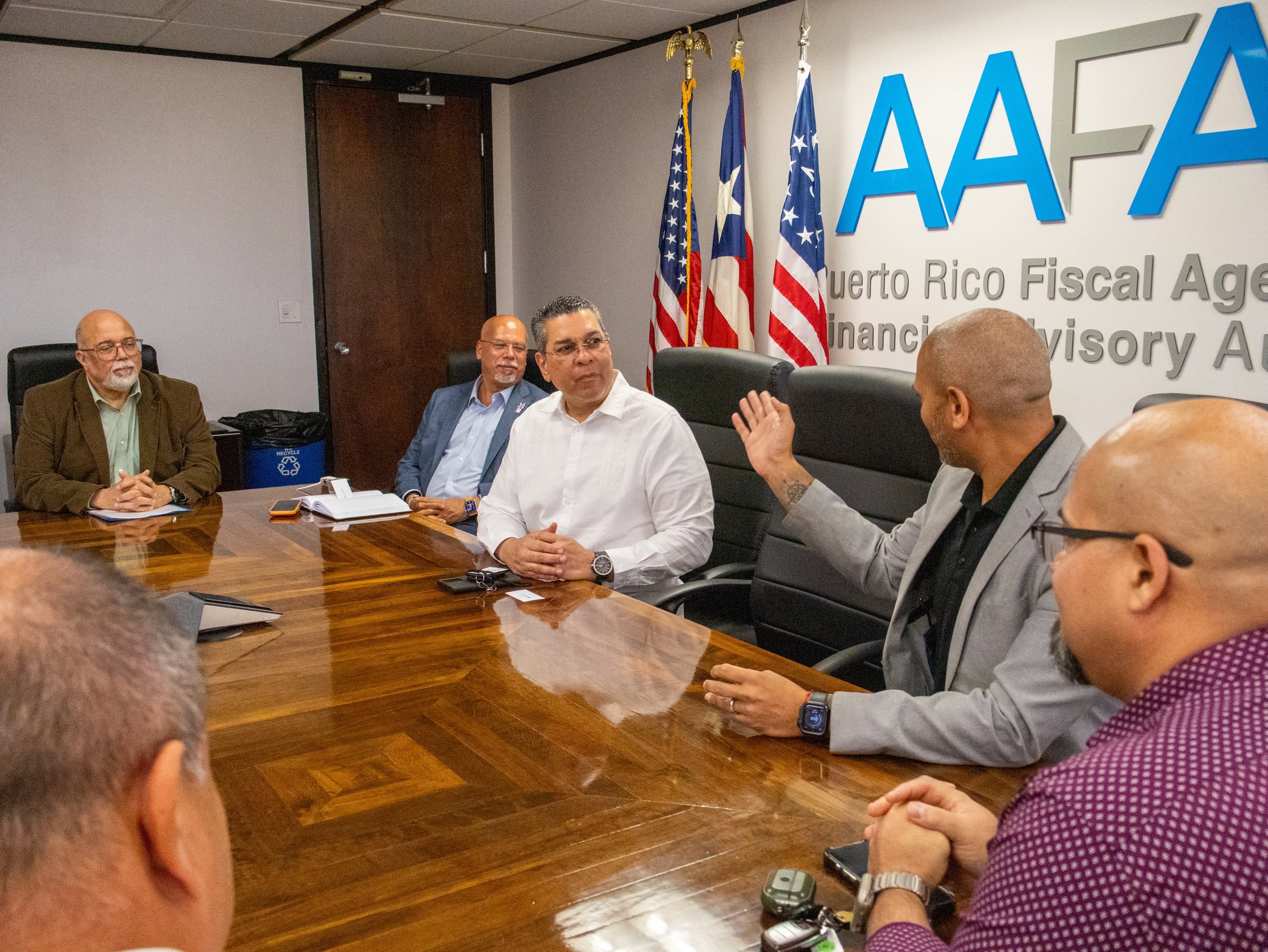 Engineer Josué A. Colón Ortiz is participating in a meeting with officials at government offices.