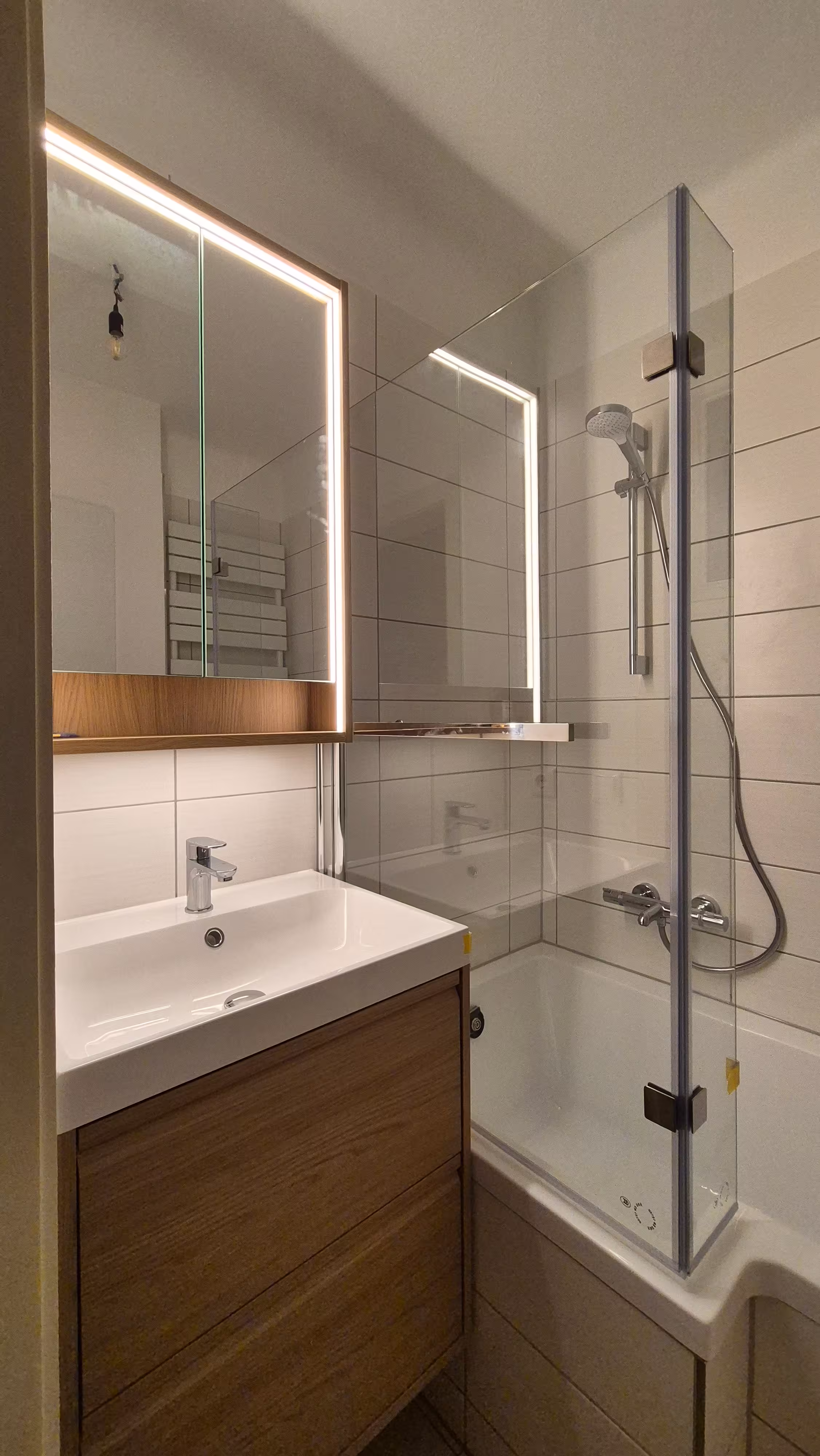 Fertiges Badezimmer mit Waschtisch, Spiegel und Badewanne