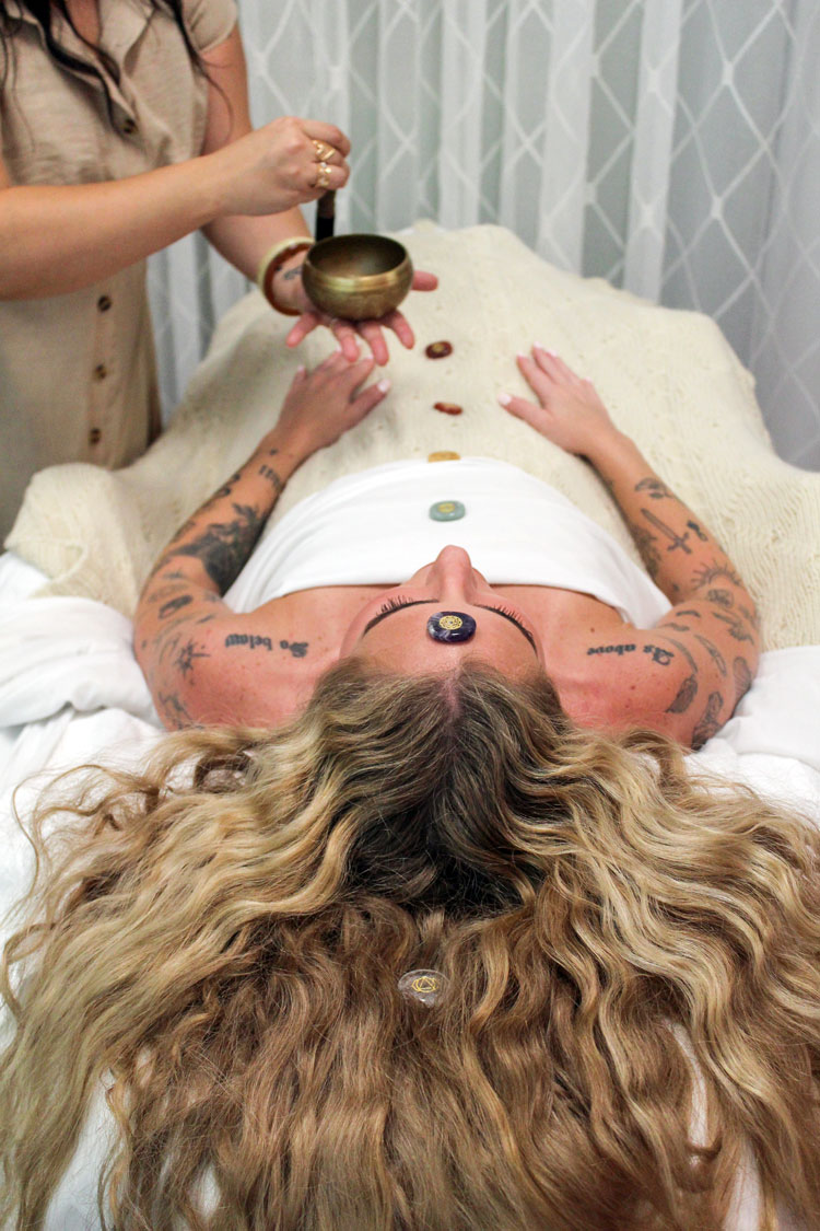 Sound healing with a bowl and chakra stones during a restorative treatment