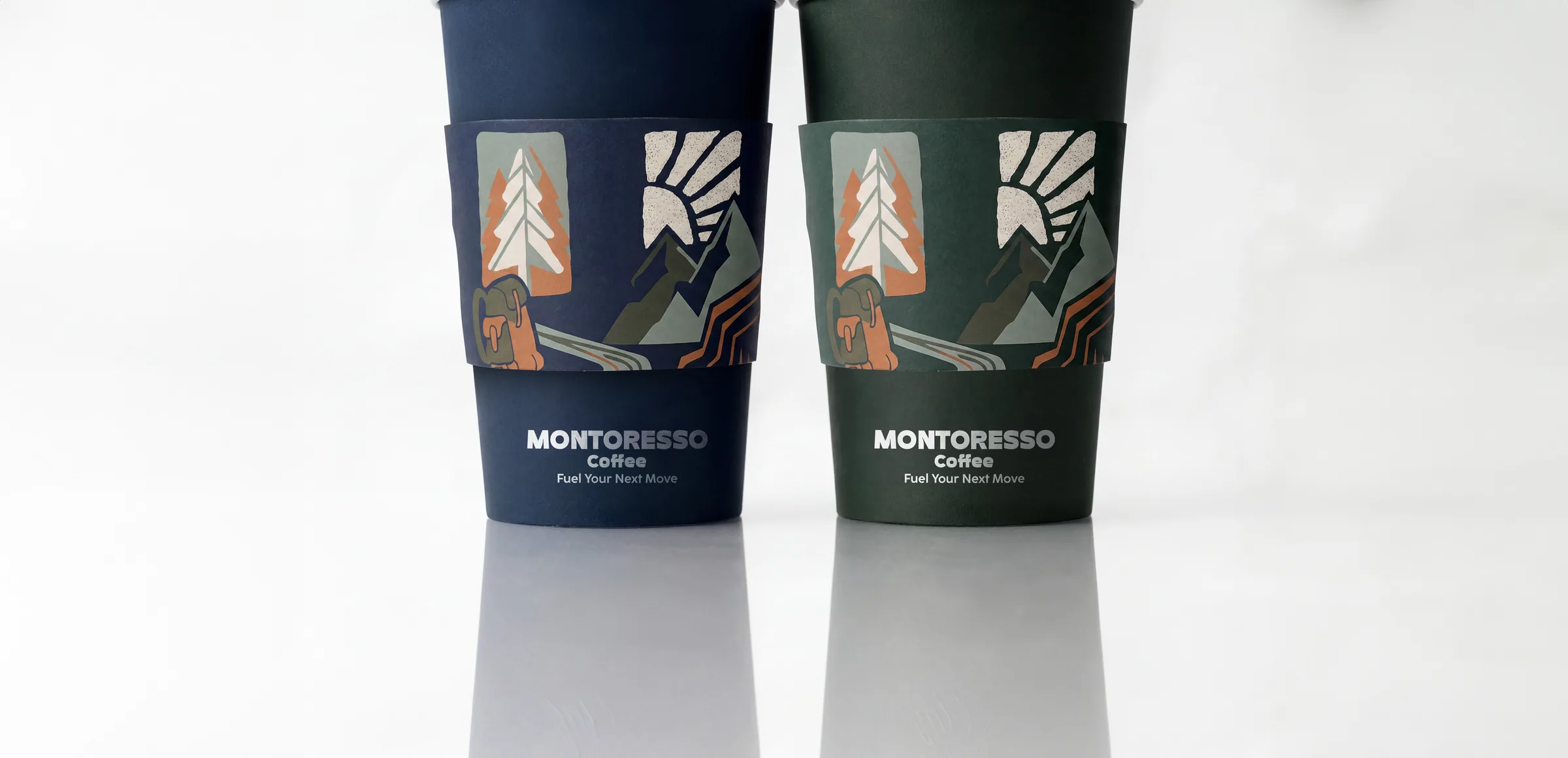 Two Montoresso cups, navy and forest green, with illustrated sleeves