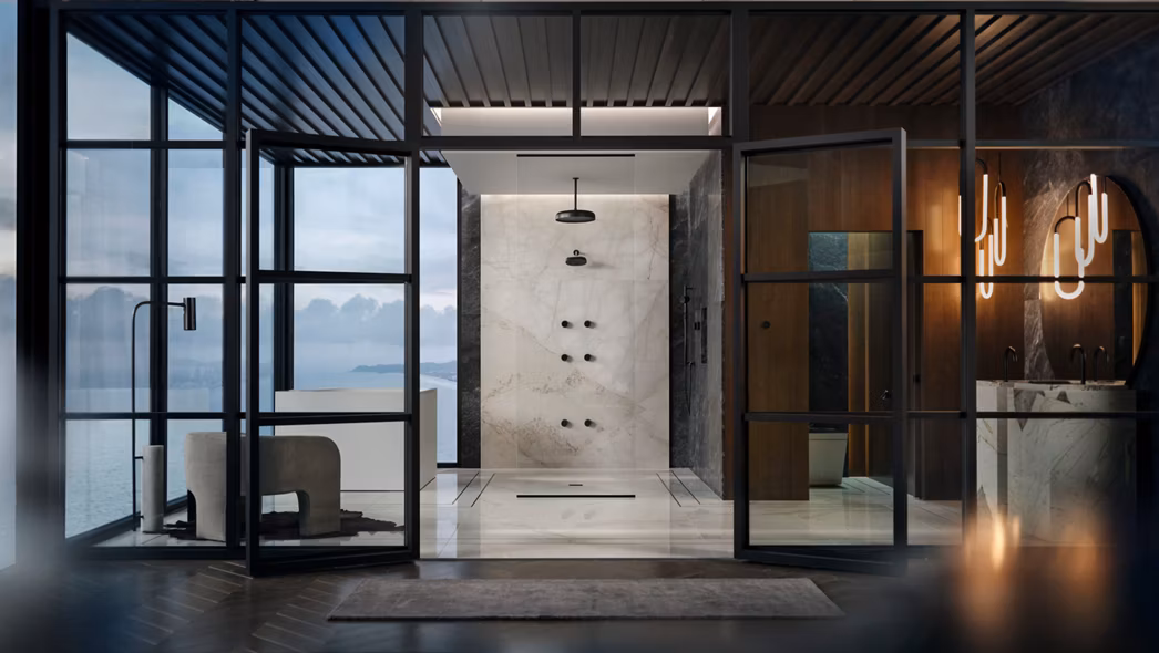 Modern glass-enclosed shower with black fixtures and marble tile, with an ocean view through floor-to-ceiling windows.