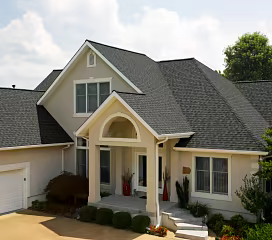 Two-story home with dimensional gray asphalt shingle roofing and light-colored siding.